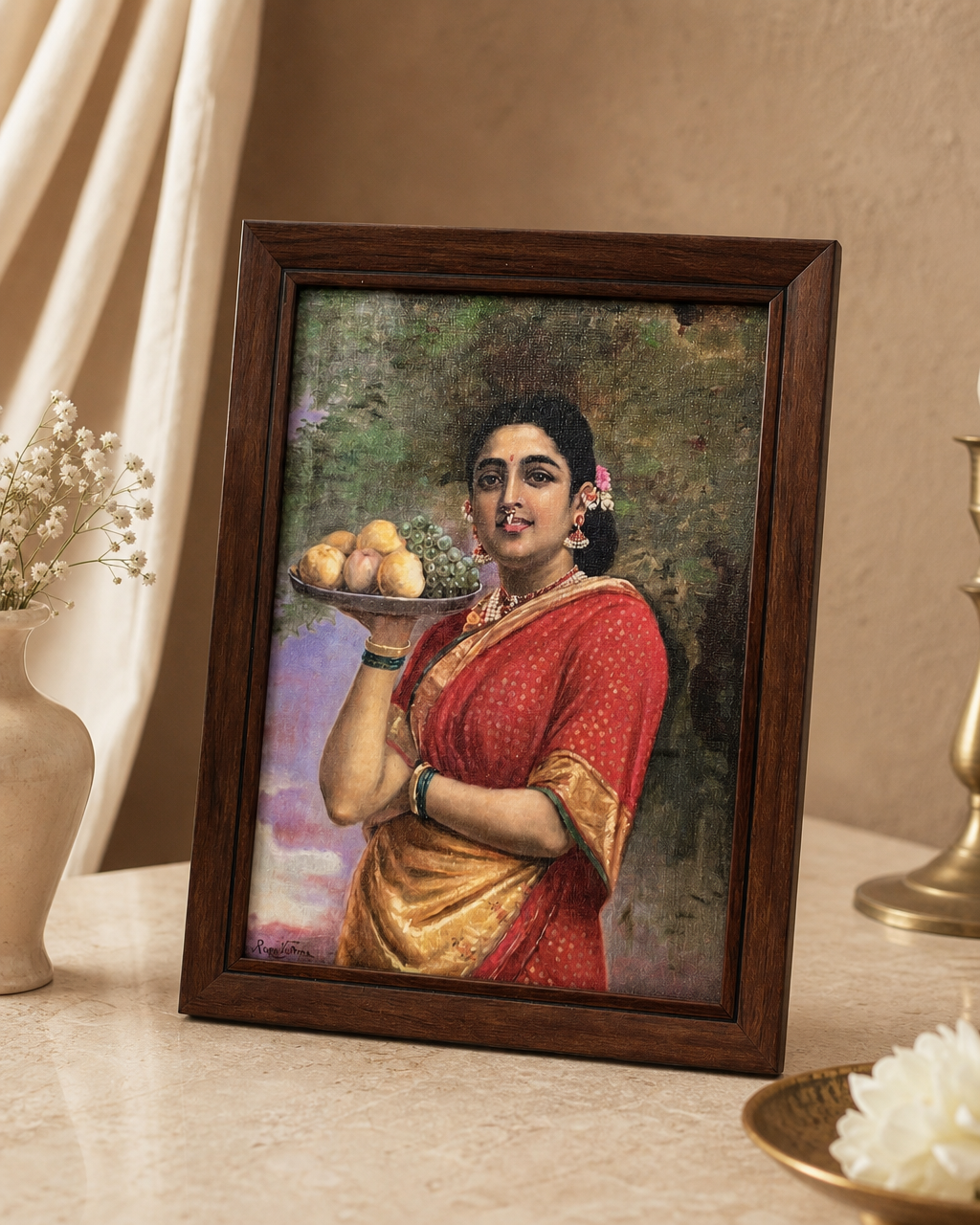 Framed Ravi Varma painting depicting a woman in a red saree holding a fruit platter.