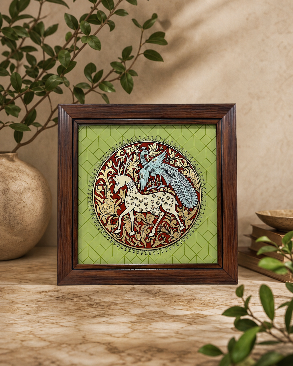 Tanjore reverse glass painting with horse and peacock in a classic wood frame on a table with plants.