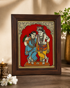 Tanjore reverse glass painting of Radha and Krishna in a wooden frame, decorative background
