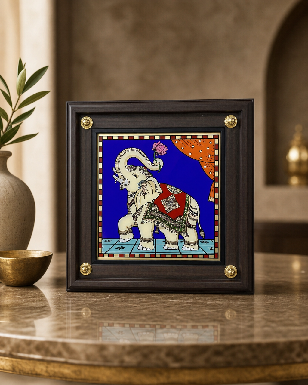 Elegant Tanjore reverse glass painting door frame with elephant design, placed on a table.