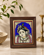 Tanjore reverse glass painting with an intricate depiction of Krishna in a wooden frame, showcasing vibrant colors and traditional design.