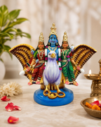 Colorful Garuda statue with deities in a decorative setting