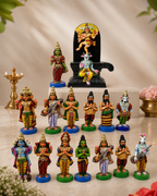 Colorful Pradosham statue set featuring various deities arranged on a marble surface.