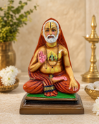 Raghavendra big handcrafted statue with vibrant colors and intricate details, set against a decorative background.