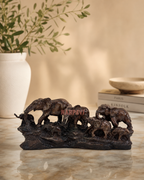 Elegant sculpture of an elephant family in a natural setting, perfect for home decor.