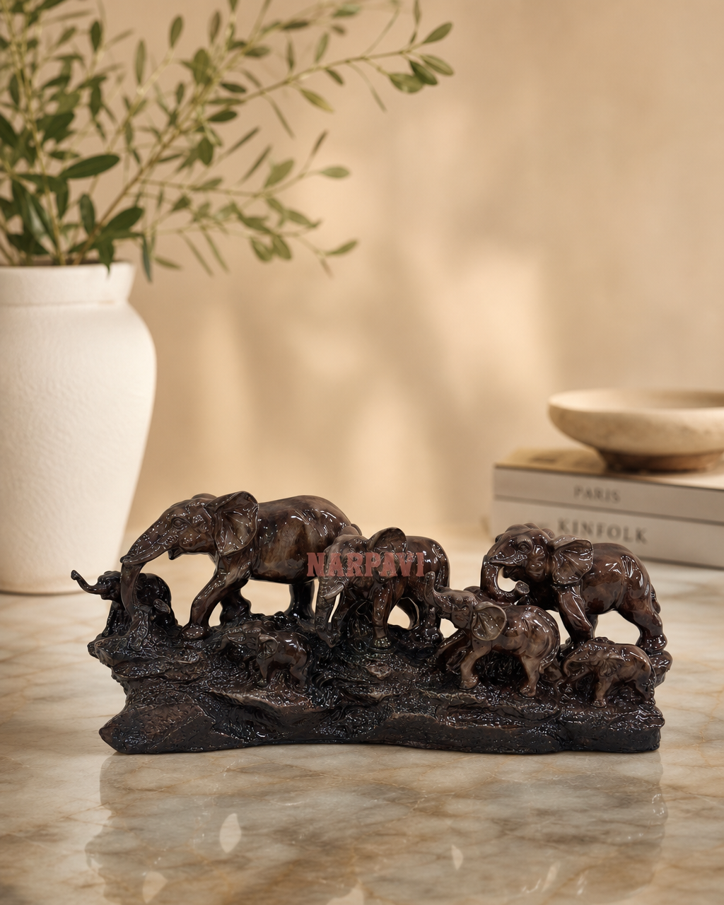 Elegant sculpture of an elephant family in a natural setting, perfect for home decor.