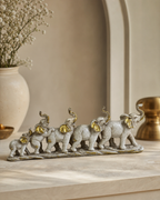 Elegant bunch of elephant figurines in a decorative arrangement on a tabletop.