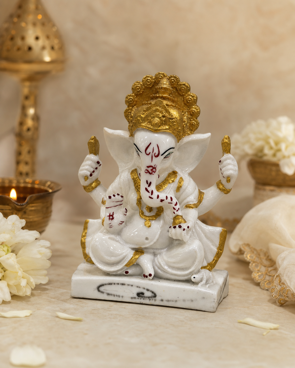 A beautifully crafted marble figurine of Ganesh Ji with golden accents and intricate details, set against a soft background.