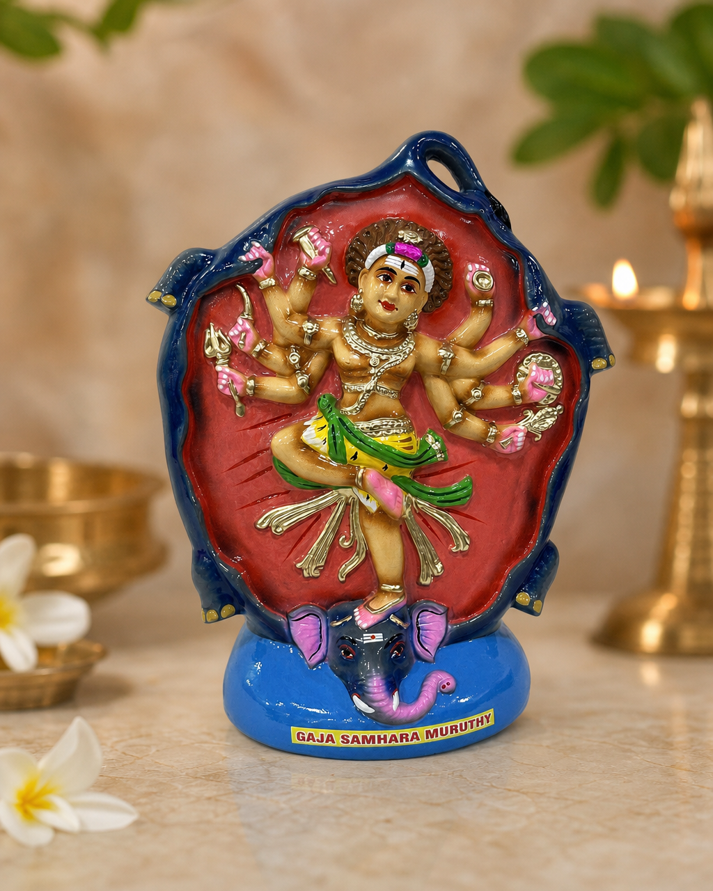 Colorful Gajasamharamurthy figurine with intricate details against a soft background.