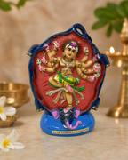 Colorful Gajasamharamurthy figurine with intricate details against a soft background.