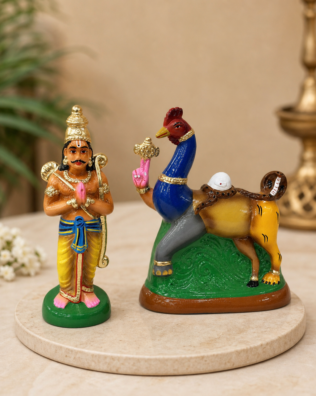 Colorful Nava Kunjaram figurine with detailed designs on a round base
