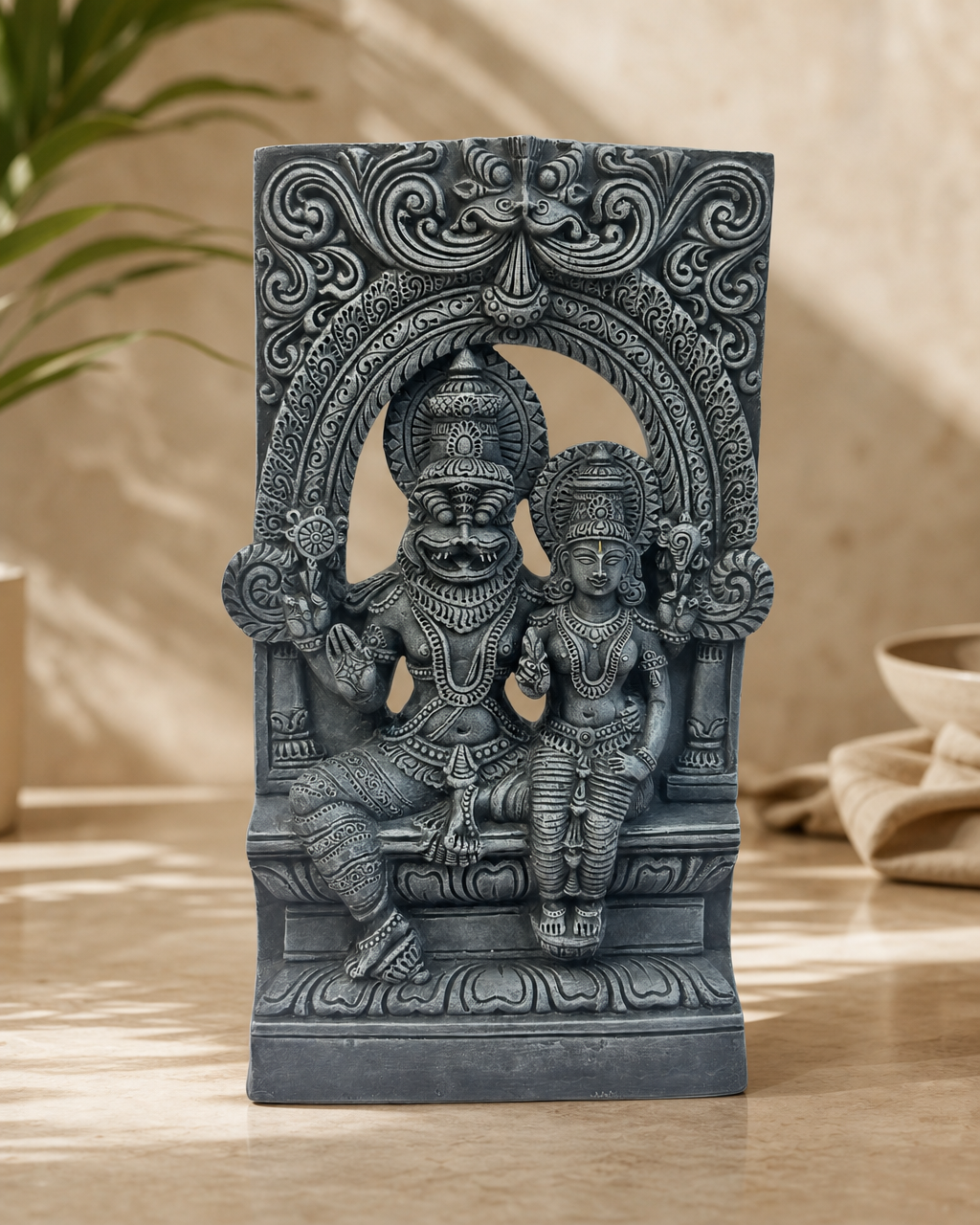 Intricate decorative statue of Lakshmi Narasimha on a table.