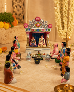 Traditional marriage figurine set with colorful figures and intricate details.