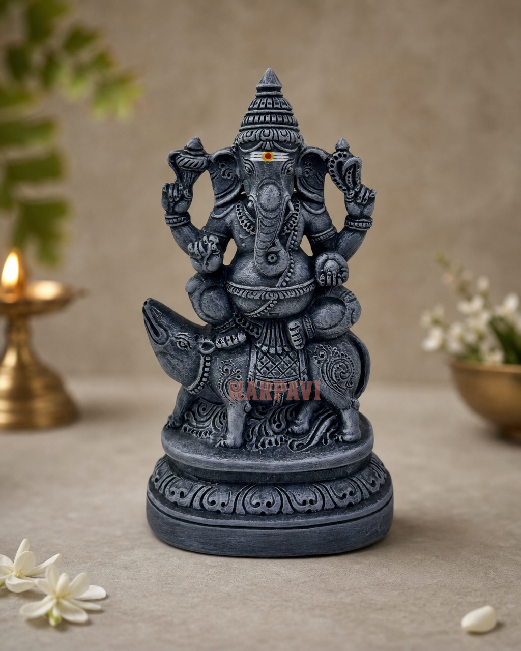 Elegant Moshigvinayagar statue placed on a table with traditional décor, showcasing intricate details and craftsmanship.