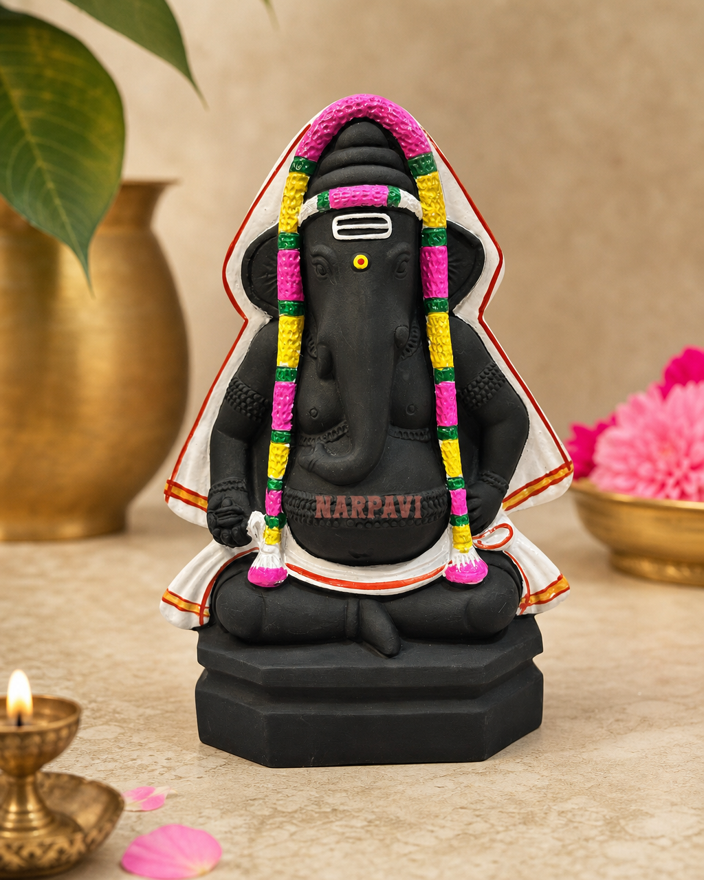 Pillayarpatti Ganesha statue with colorful garland, perfect for home decor.
