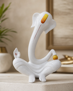 Elegant Ganesha figurine with a smooth, modern design placed on a neutral background.