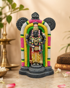 Colorful Guruvayur Krishna statue with intricate detailing, set on a decorative table.