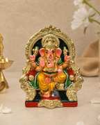 Colorful Raja Ganapathy Paper Mache statue with intricate gold details, seated on an ornate chair.