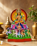 Colorful statue of Surya Narayanan with horses and vibrant decor.