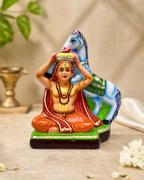 Colorful Vathi Raja Theerthar statue with intricate details and vibrant colors, featuring a seated figure with a horse.