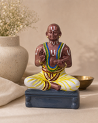 Beautifully crafted Desigar figurine in a meditative pose on a decorative base.