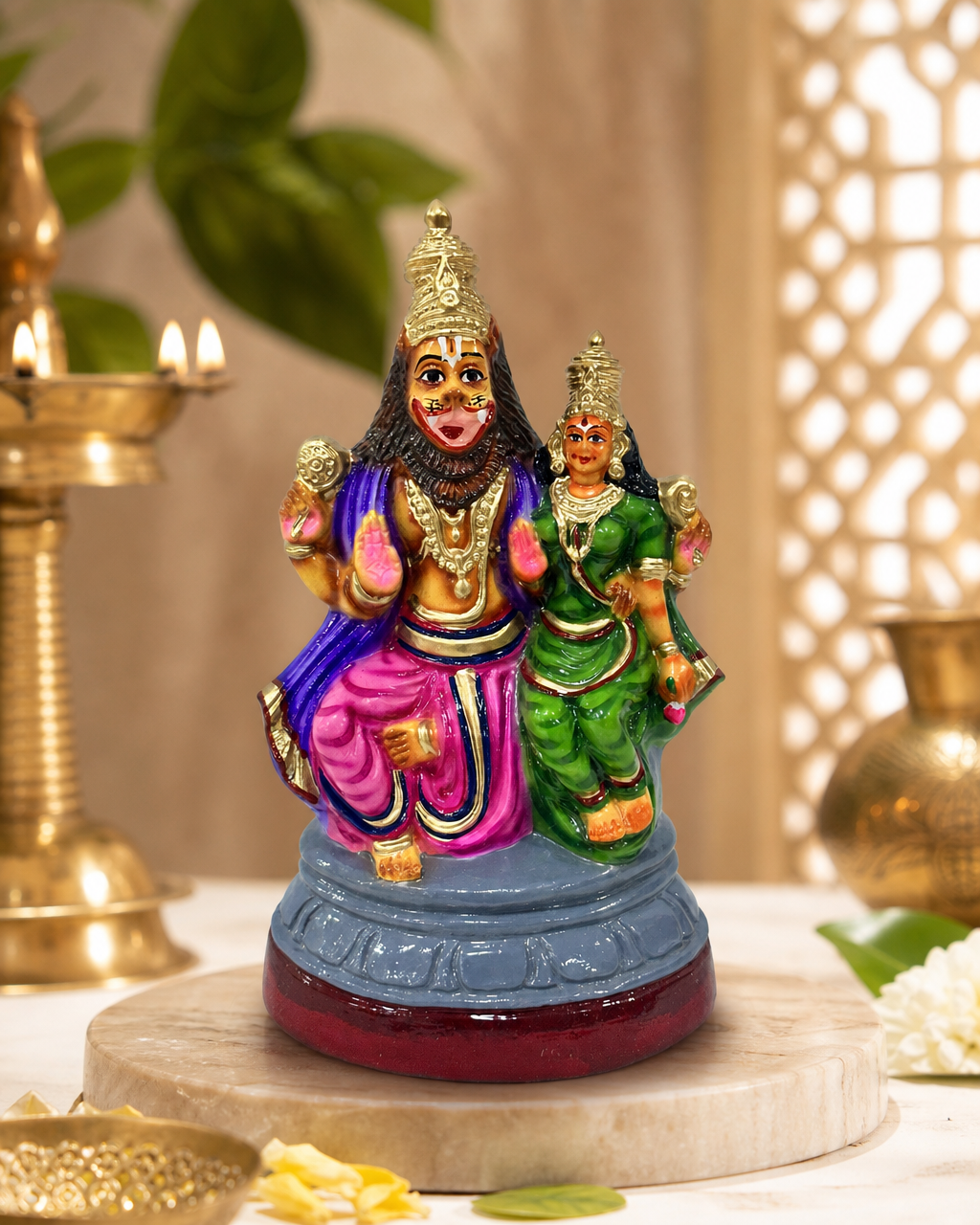 Colorful Lakshmi Narasimha figurine with intricate detailing on a decorative surface.
