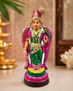 Colorful Aandal figurine with intricate details and vibrant colors, placed on a decorative surface.