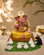 Decorative Ganapathy statue with traditional attire and offerings