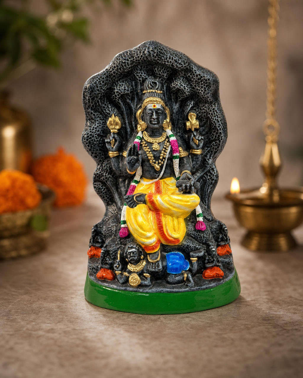 Colorful Maram Dakshina Murthy statue with intricate details and vibrant clothing.