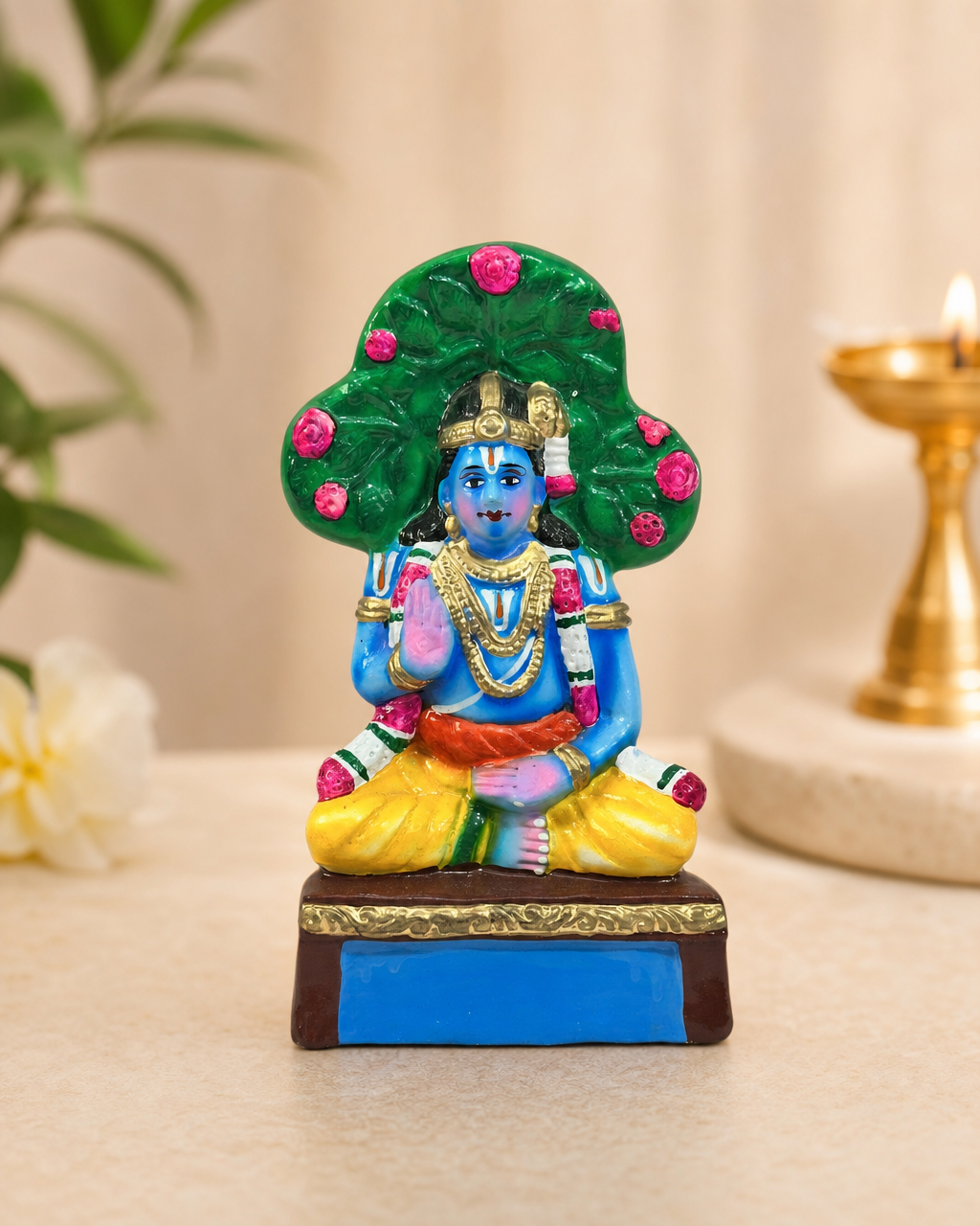 Colorful Nammazhvar figurine with vibrant details and intricate design, set against a subtle background.