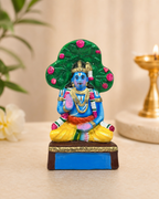 Colorful Nammazhvar figurine with vibrant details and intricate design, set against a subtle background.