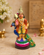 Colorful Nindra Mayil Murugan statue with peacock, richly detailed in a decorative setting.