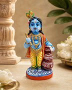 Intricately designed Paanai Krishna figurine with vibrant colors and detailed features.