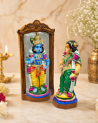 Colorful Raadhai Maalai Suduthal set with intricate design, featuring vibrant figurines on a marble background.