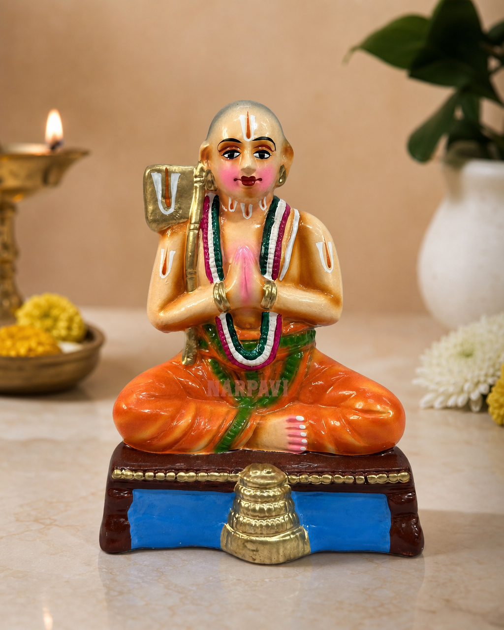 Ramanujar figurine with intricate detailing on a decorative base