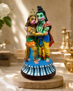 Colorful Rama and Hanuman figurine on a decorative base.