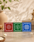 Decorative Kolam set with intricate designs in red, green, and blue tiles, displayed with a traditional decor background.