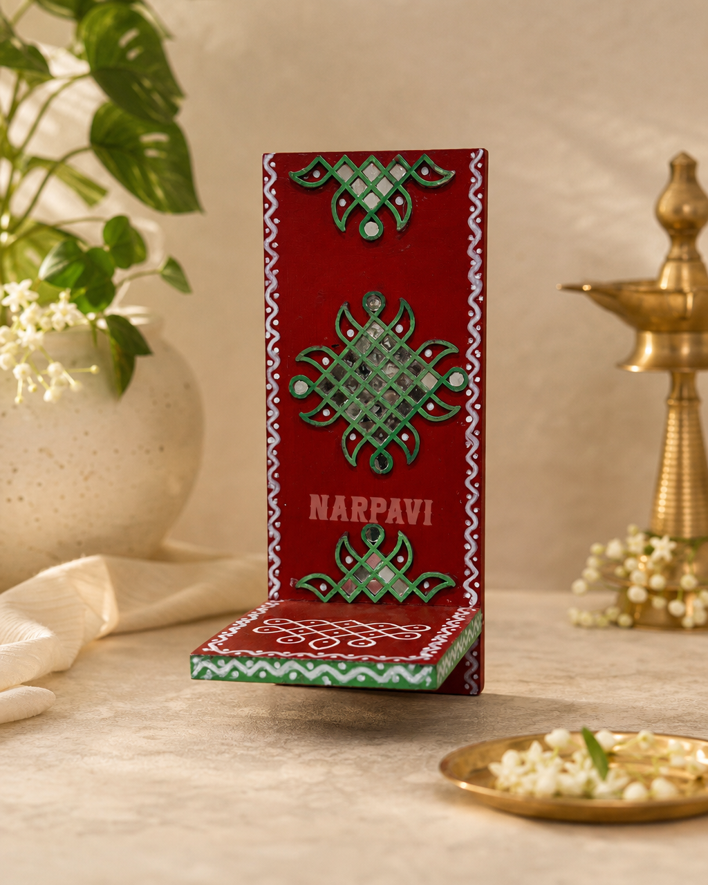 Elegant Hanging Lippon with intricate green and red patterns on a decorative stand.